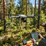 DJI LiDAR drone capturing forest terrain data for precise aerial mapping.