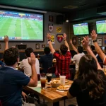 Enjoying live football action with friends, tuning into truc tiep bong da hom nay in a sports bar atmosphere.